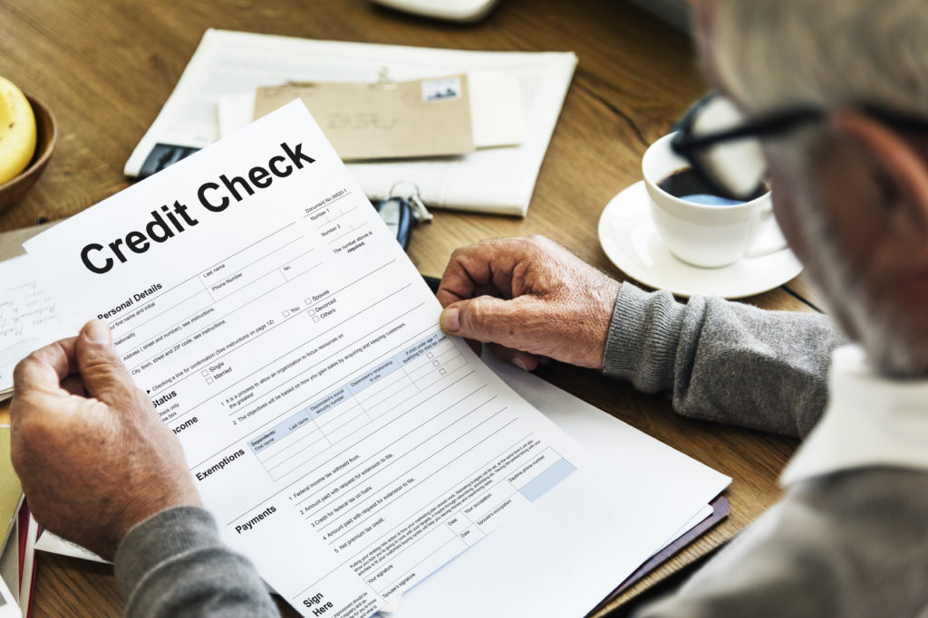 man looking at credit check document