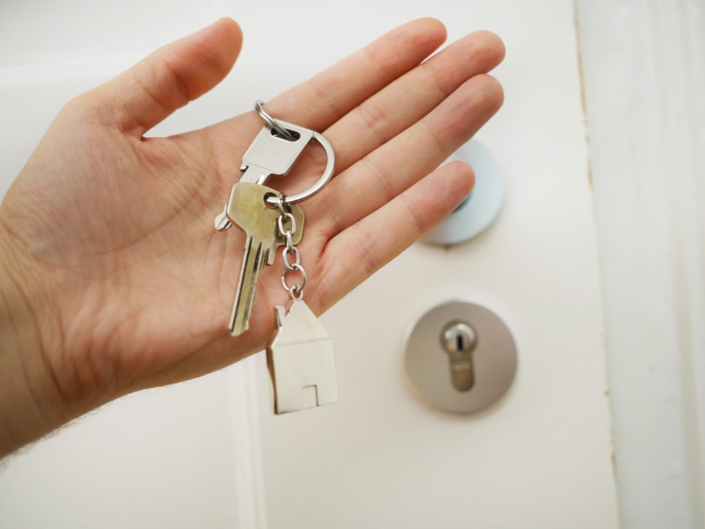 Person holding keys for house
