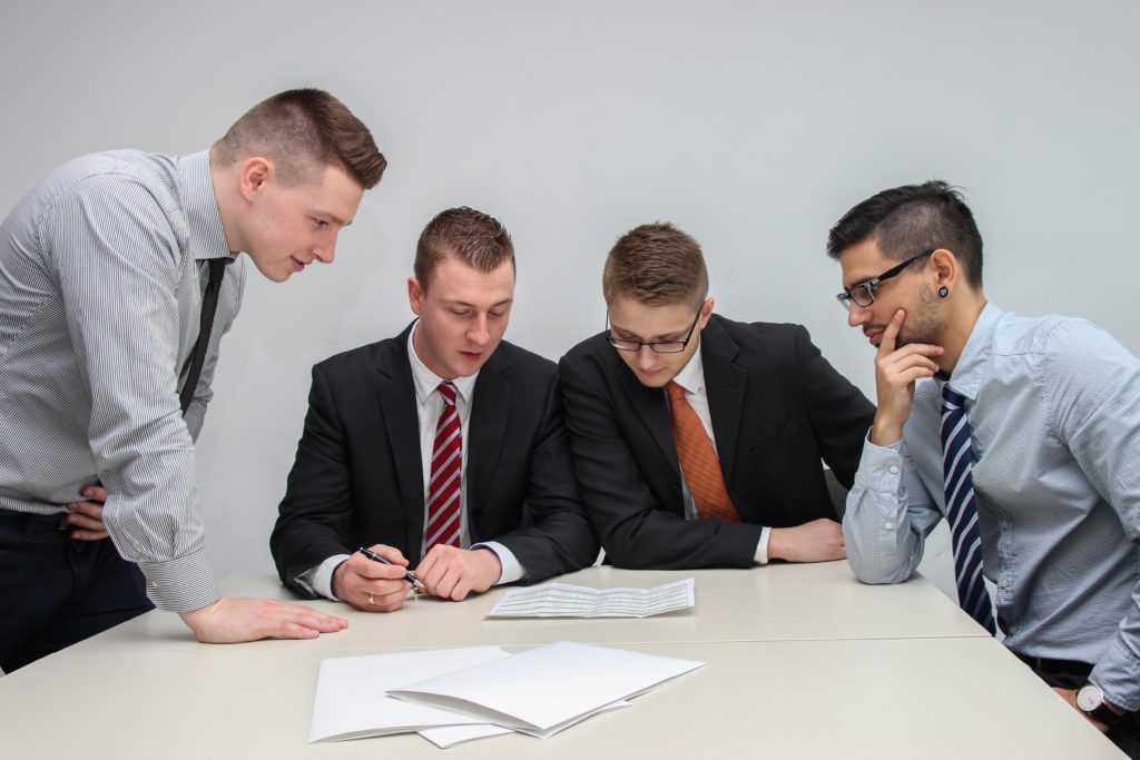 creditors meeting together and looking through paperwork