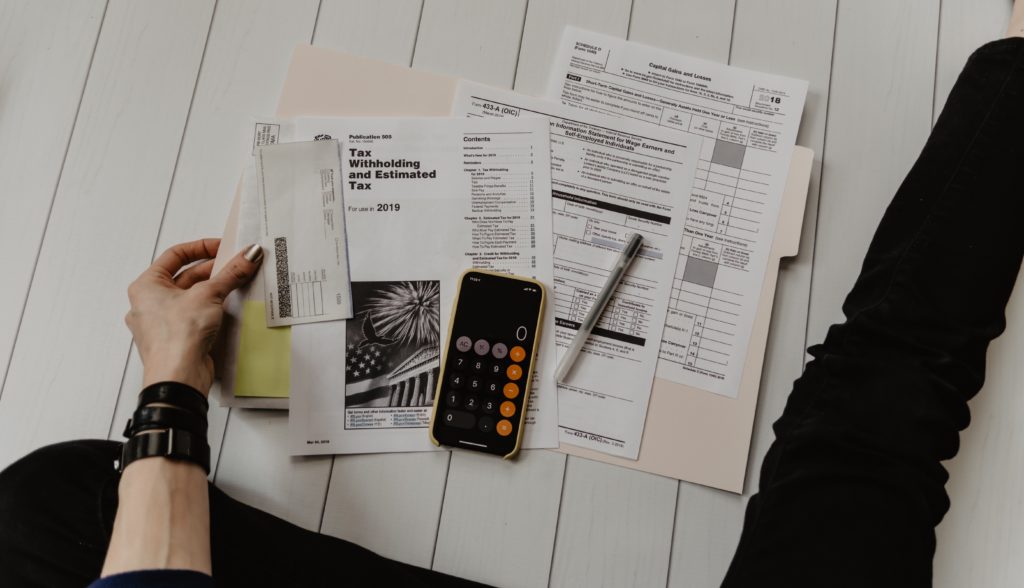 man working out his taxes with a calculator