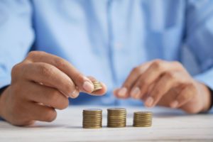 man stacking change