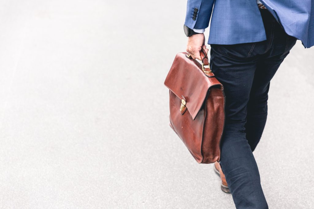 Man walking to work with briefcase in hand