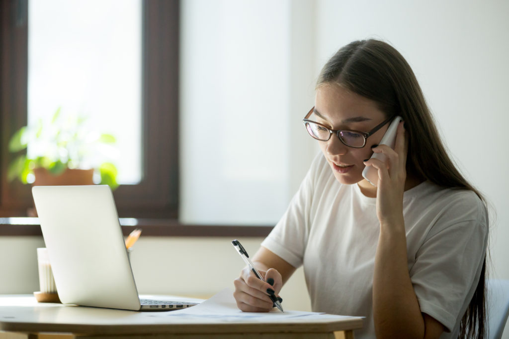 Woman on phone to bank to report mistakes on credit report