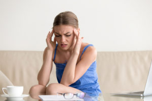 teen girl having panic attack feeling dizzy headache massaging